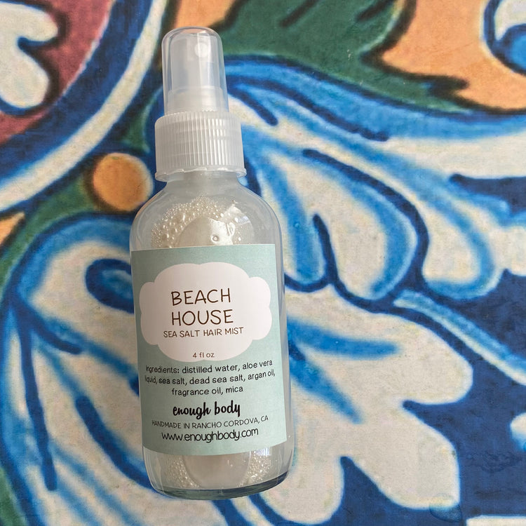 Beach House sea salt hair mist bottle on a colorful background