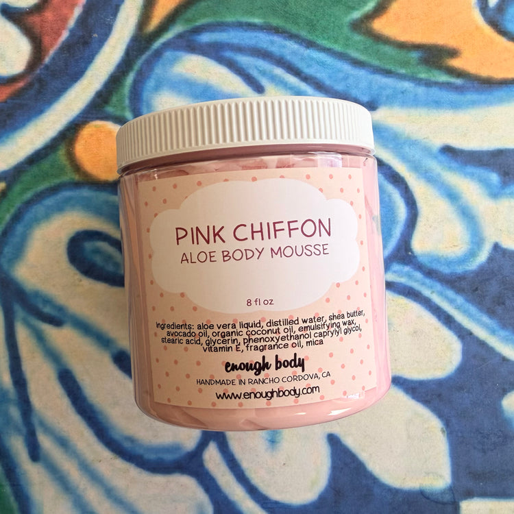 Pink Chiffon aloe body mousse jar with a colorful patterned background