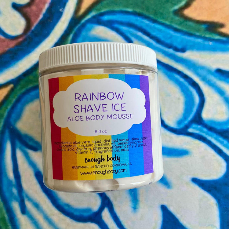 Jar of rainbow shave ice Aloe Body Mousse on a colorful background