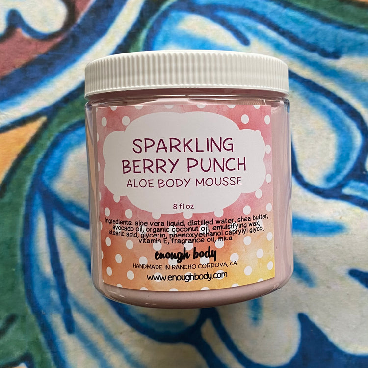 Jar of Sparkling Berry Punch Aloe Body Mousse with a colorful background