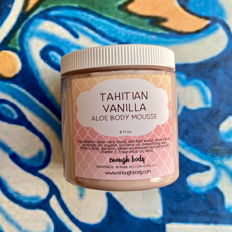 Jar of Tahitian Vanilla Aloe Body Mousse with decorative label on a colorful background