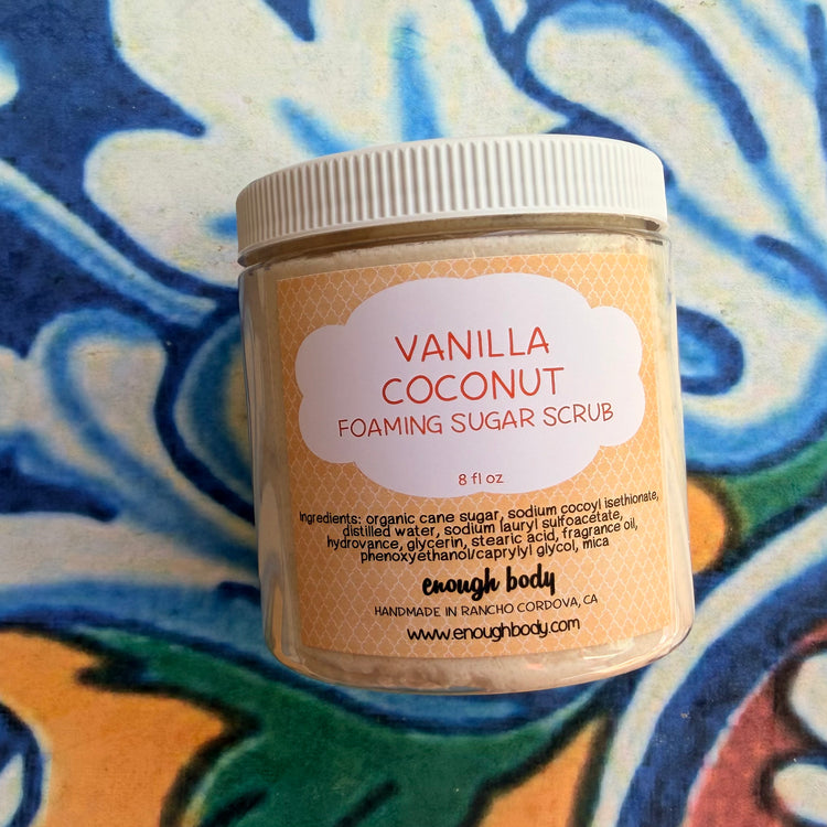 Jar of Vanilla Coconut Foaming Sugar Scrub on a colorful patterned background