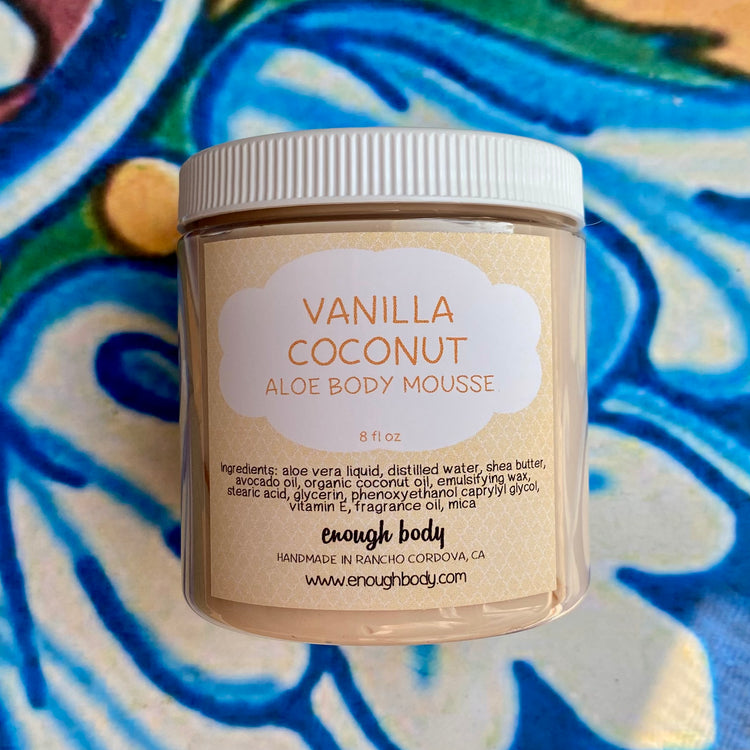 Vanilla Coconut Aloe Body Mousse jar with a colorful patterned background