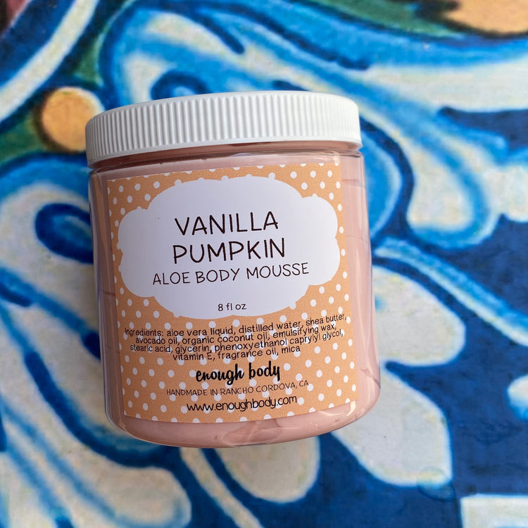 Jar of Vanilla Pumpkin Aloe Body Mousse on a colorful background