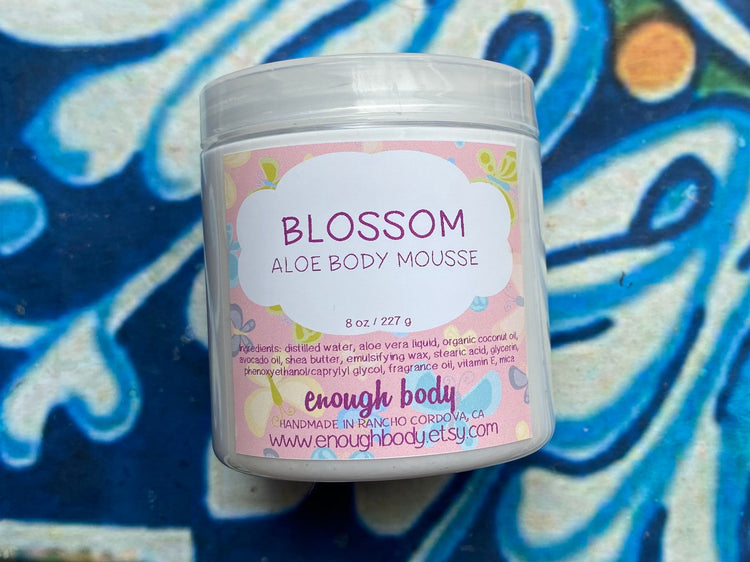 Jar of blossom aloe Body Mousse on a colorful background