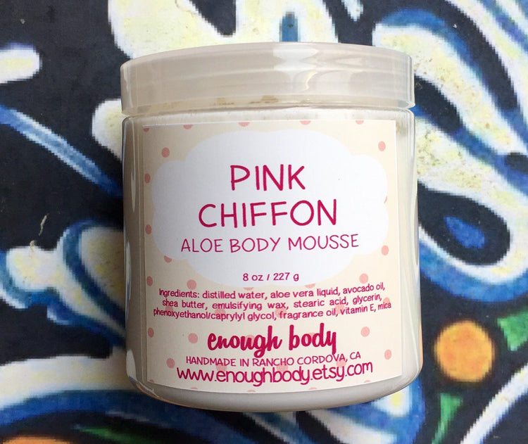 Jar of pink chiffon Aloe Body Mousse on a colorful background