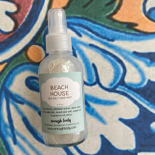 Beach House sea salt hair mist bottle on a colorful background