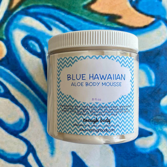 Jar of blue hawaiian Aloe Body Mousse on a colorful background
