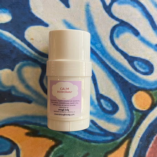 Deodorant stick with a purple label on a colorful abstract background