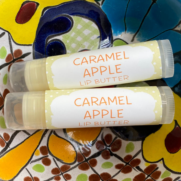 Two tubes of caramel apple lip butter on a colorful background