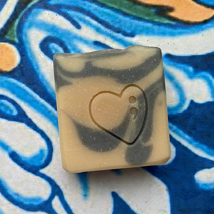 Bar of soap with a heart design on a colorful background