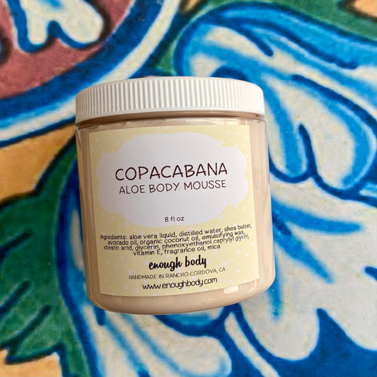Jar of Copacabana Aloe Body Mousse on a colorful background