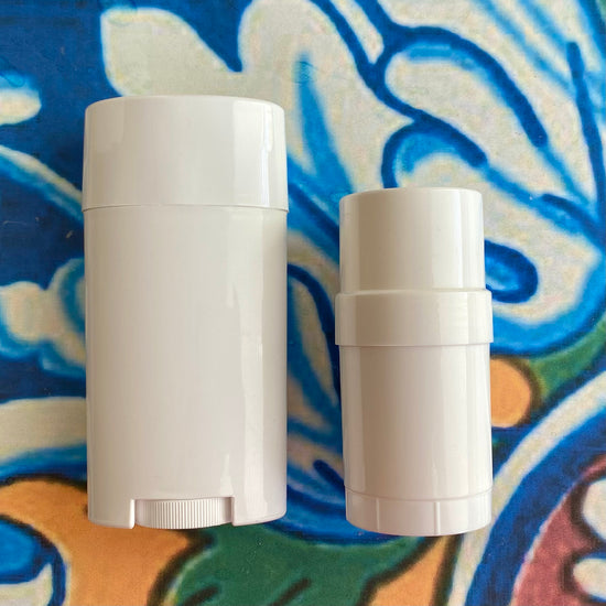 Two white deodorant containers on a colorful abstract background