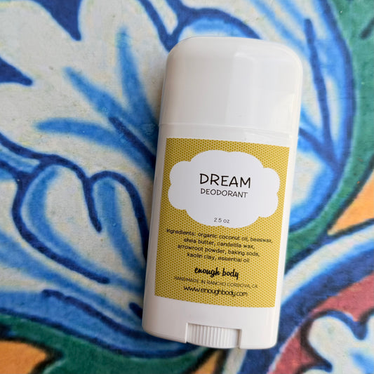 Deodorant stick with 'Dream' label on a colorful background