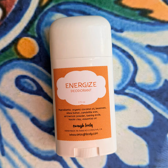 Deodorant stick with 'Energize' label on a colorful background
