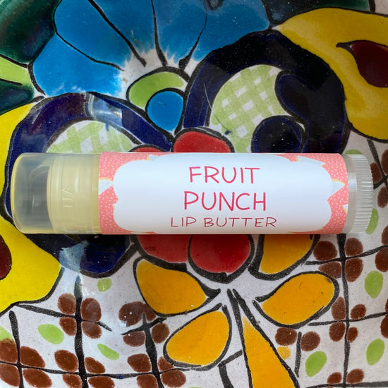 Lip butter labeled 'Fruit Punch' on a colorful floral plate