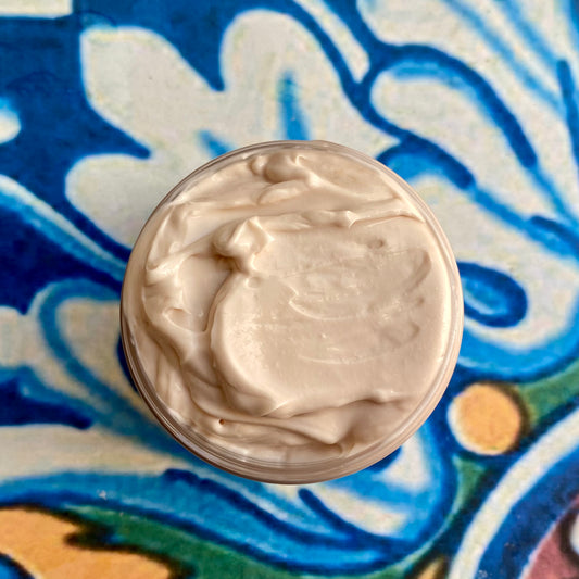 Close-up of a container of cream on a decorative blue and white background