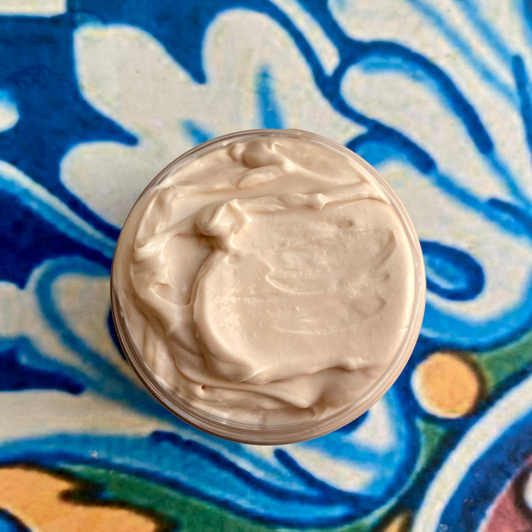 Close-up of a container of cream on a decorative blue and white background
