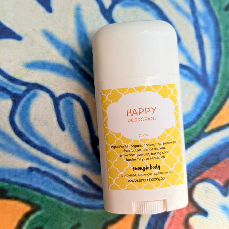 Deodorant stick with a yellow label on a colorful abstract background