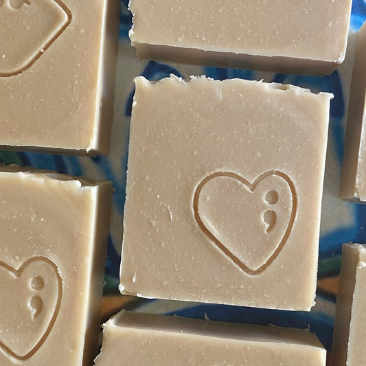 Square bars of soap with a heart design on a blue background