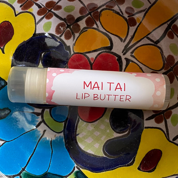 Lip butter labeled 'Mai Tai' on a colorful floral background
