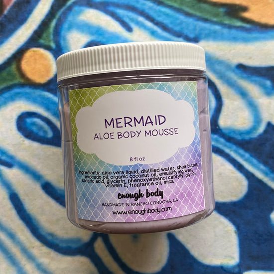 Jar of Mermaid Aloe Body Mousse on a colorful background