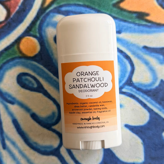Orange Patchouli Sandalwood deodorant stick on a colorful background