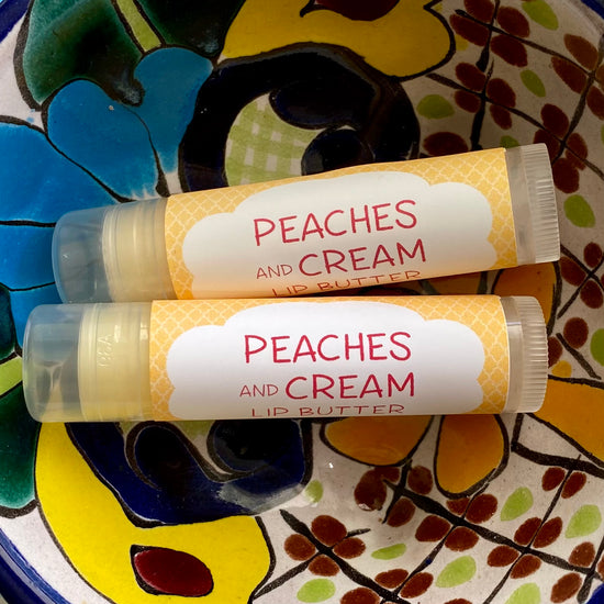 Two tubes of peaches and cream lip butter on a colorful background