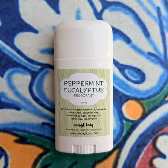 Peppermint Eucalyptus deodorant stick on a colorful fabric background
