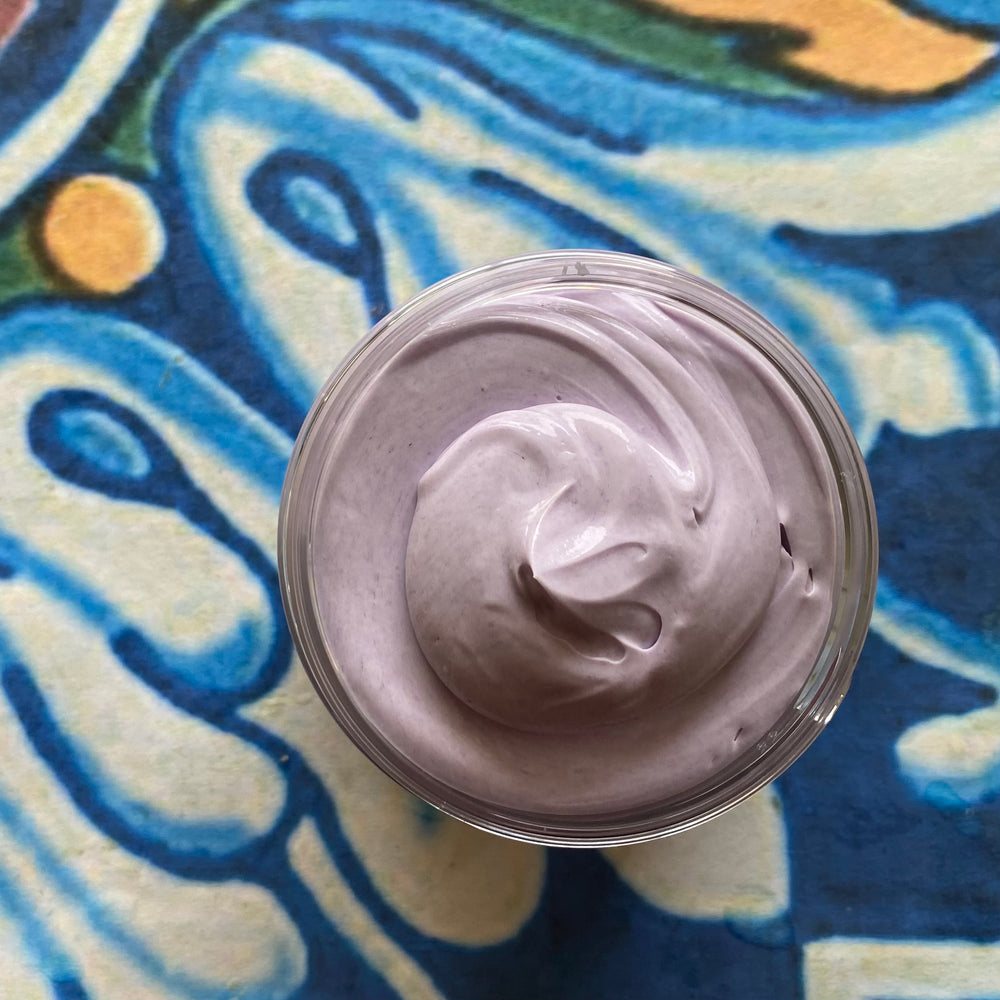 Jar of purple cream on a colorful abstract background