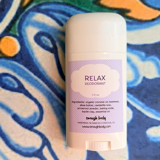 Deodorant stick with 'Relax' label on a colorful abstract background