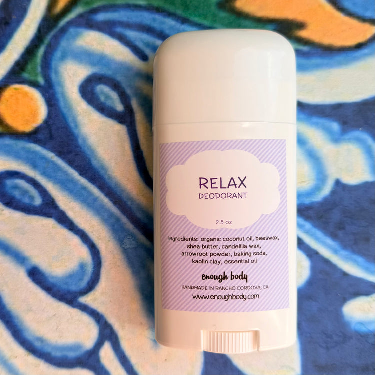 Deodorant stick with 'Relax' label on a colorful abstract background
