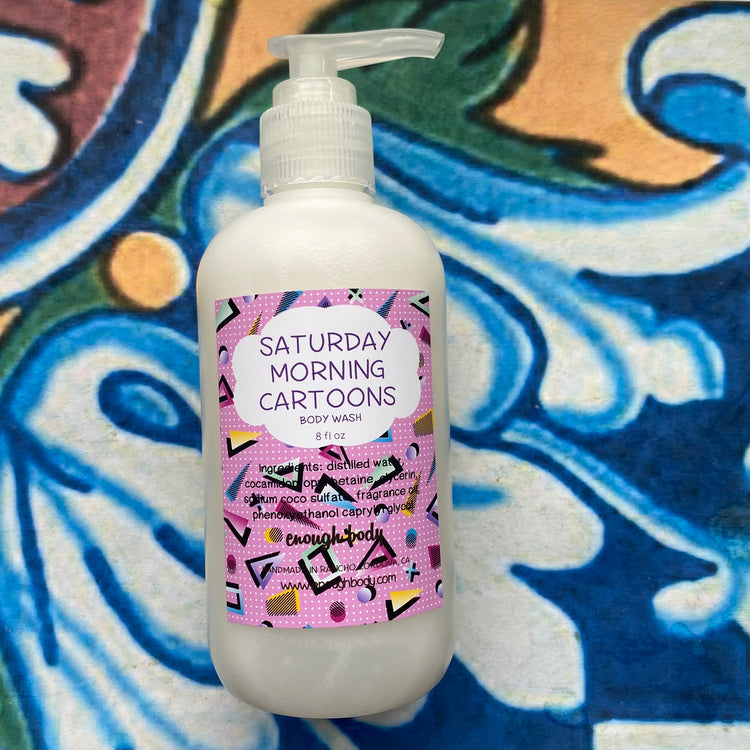 Body wash bottle with 'Saturday Morning Cartoons' label on a colorful abstract background