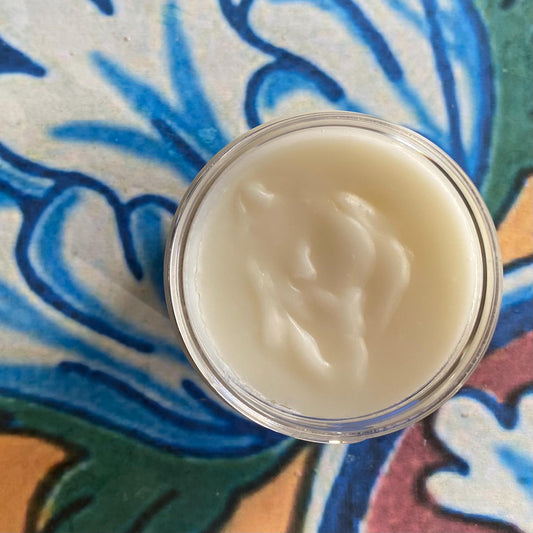 Jar of cream on a colorful, patterned surface
