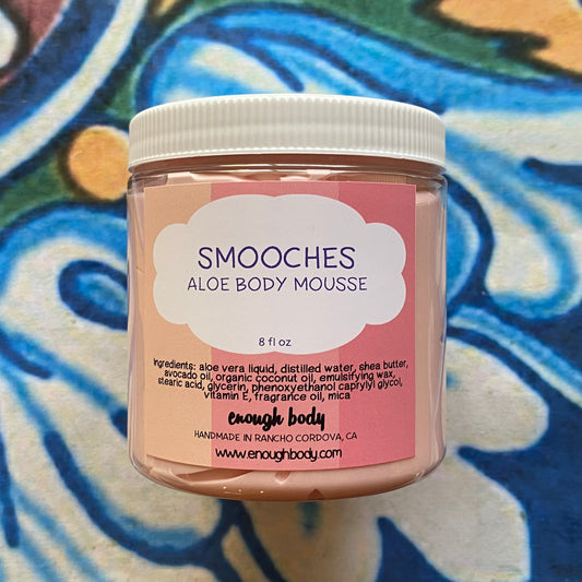 Jar of Smooches Aloe Body Mousse on a colorful patterned background