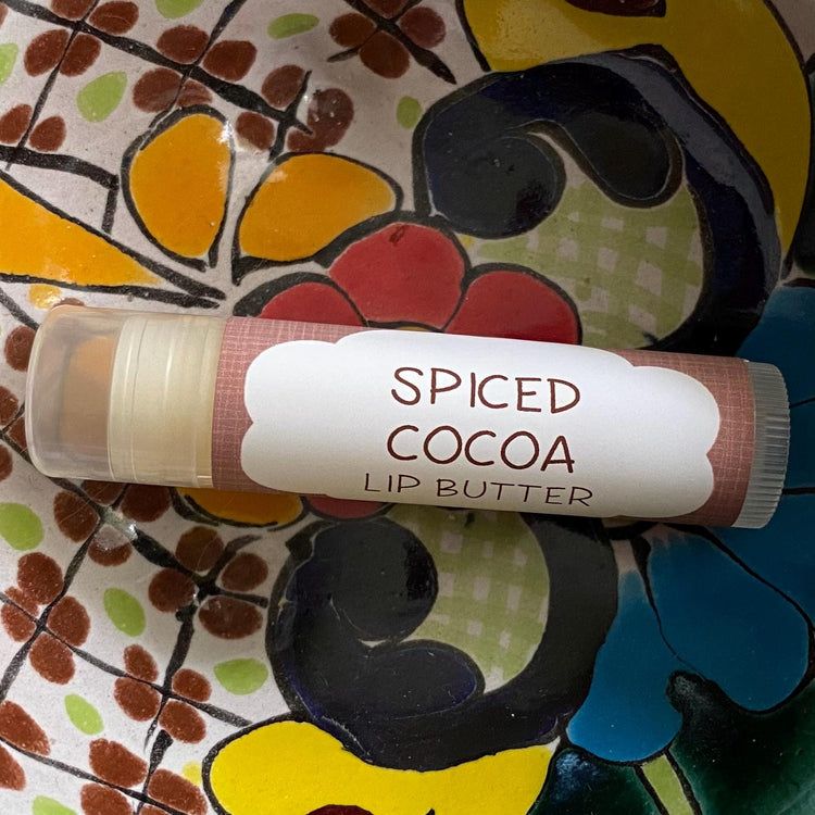 Spiced cocoa lip butter on a colorful floral plate