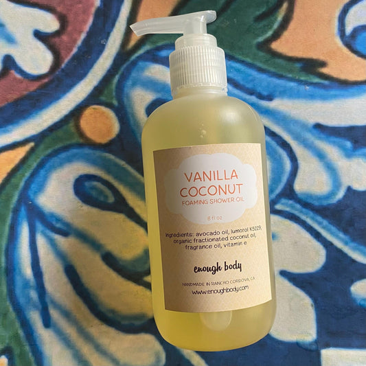 Bottle of Vanilla Coconut foaming shower oil with a colorful patterned background
