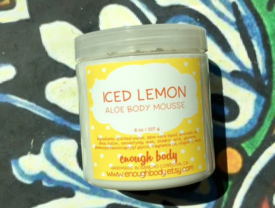 Jar of iced lemon Aloe Body Mousse on a colorful background