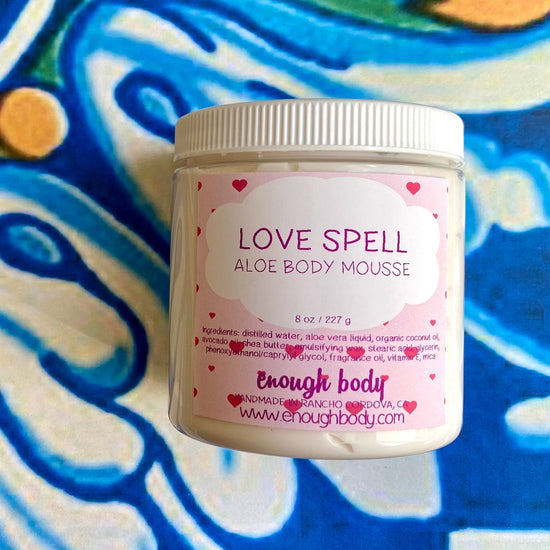 Jar of lovespell Aloe Body Mousse on a colorful background